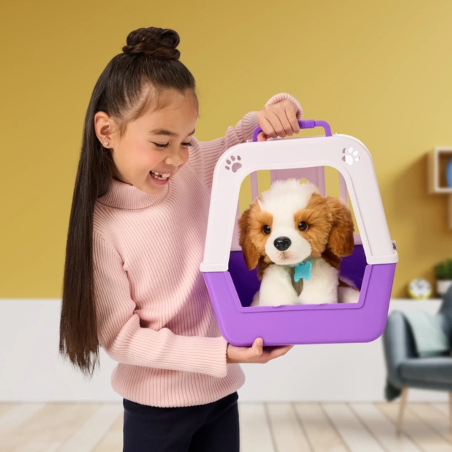 Child holding a purple pet carrier with Little Live Pets - My Really Real Puppy Patches inside against a yellow wall.