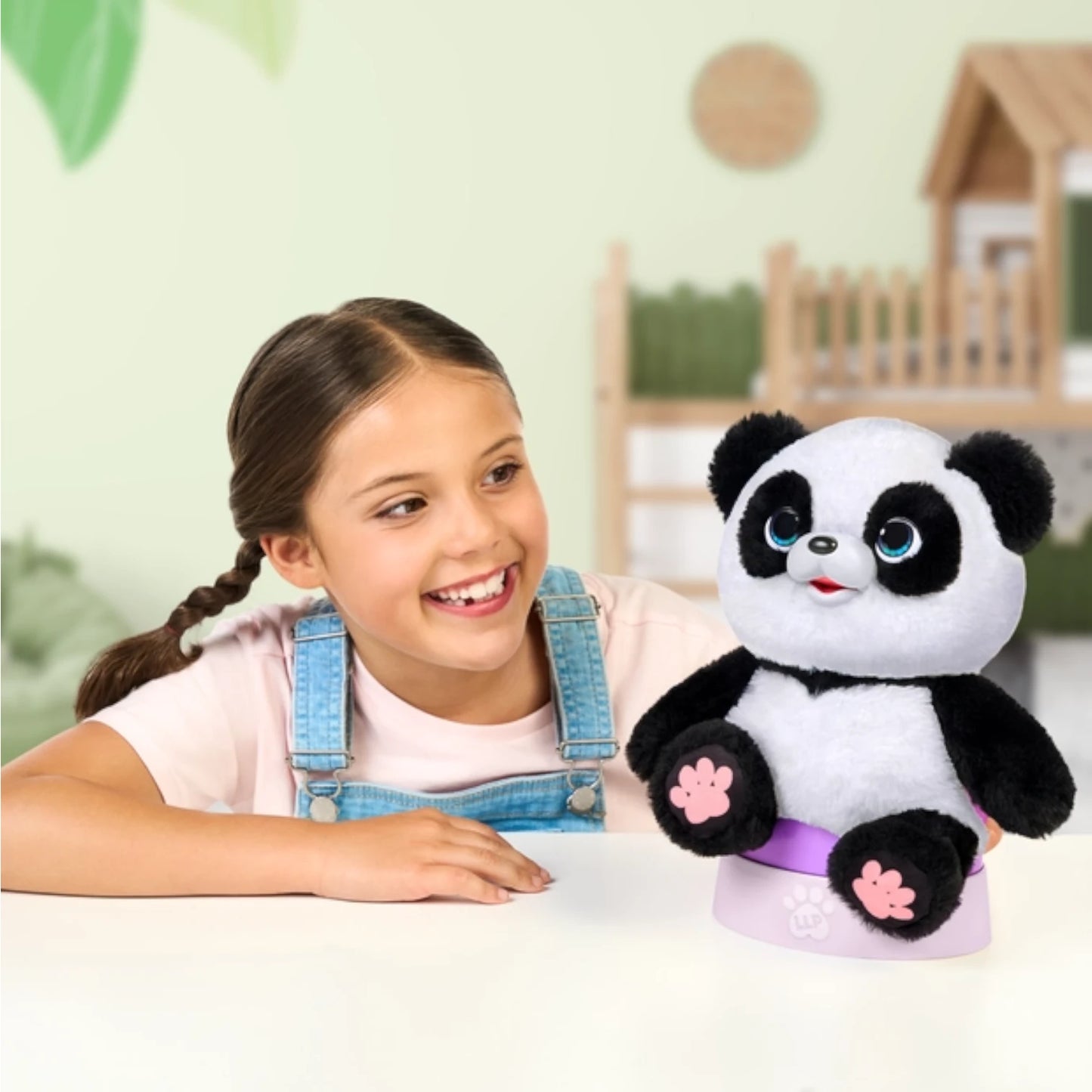 Young girl holding a Little Live Pets - My Baby Panda Chuchu plush panda toy in a bright room