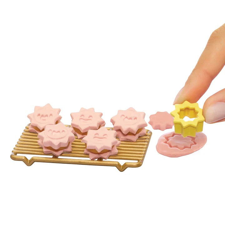 Pink flower-shaped cookies on a cooling rack with a yellow cookie cutter. Miniverse Make It Mini From Scratch Series 2