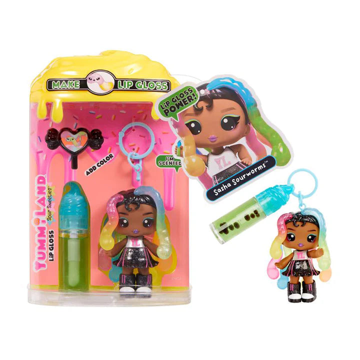 Yummiland Sour Sweeties Sasha Sourworms doll with rainbow hair, black outfit, and glitter boots, shown with DIY lava lamp lip gloss kit components including green lip gloss tube, scented drop packet, and keychain ring.