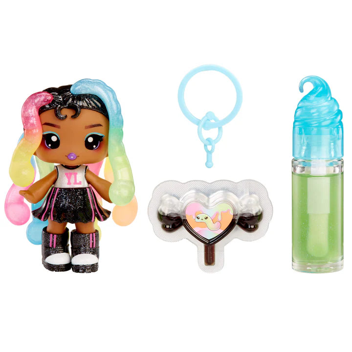 Yummiland Sour Sweeties Sasha Sourworms doll with rainbow hair, black outfit, and glitter boots, shown with DIY lava lamp lip gloss kit components including green lip gloss tube, scented drop packet, and keychain ring.