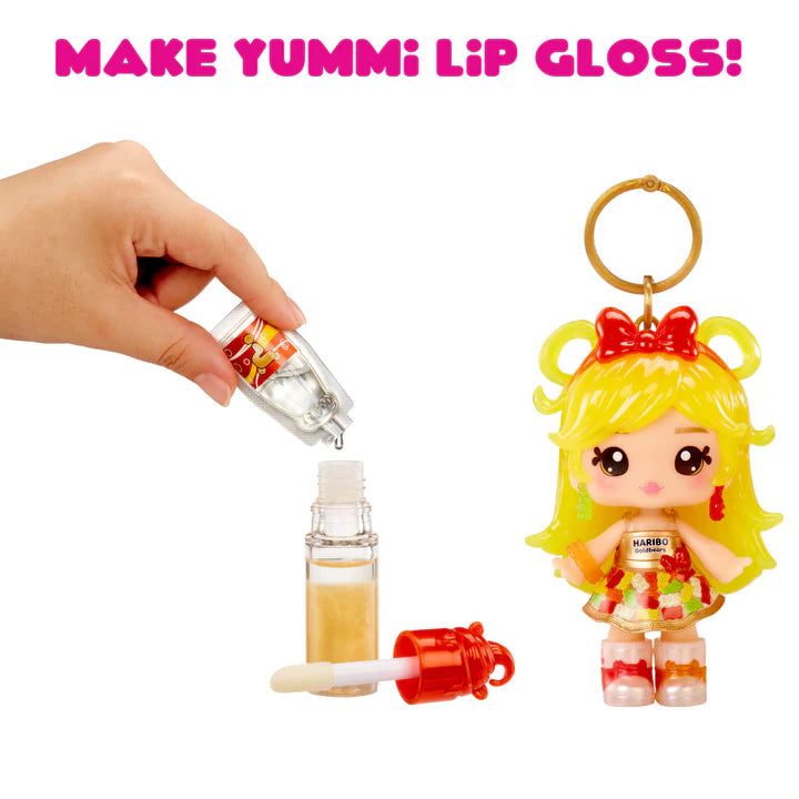 Make Yummi lip gloss kit with a small doll figure and lip gloss applicators on a white background.