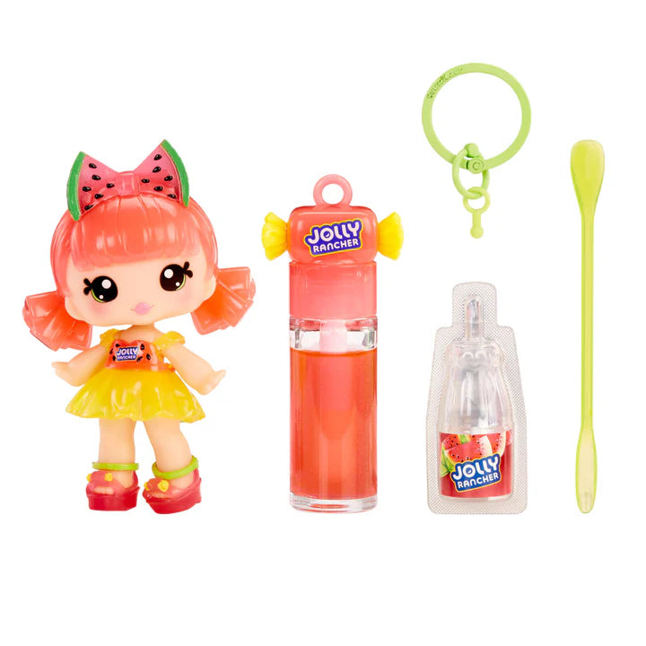 Yummiland x JOLLY RANCHER Watermelon lip gloss doll with pink hair and a watermelon bow, wearing a yellow dress, shown with DIY lip gloss kit components including pink lip gloss tube, scented liquid packet, stirring spoon, and keychain ring.