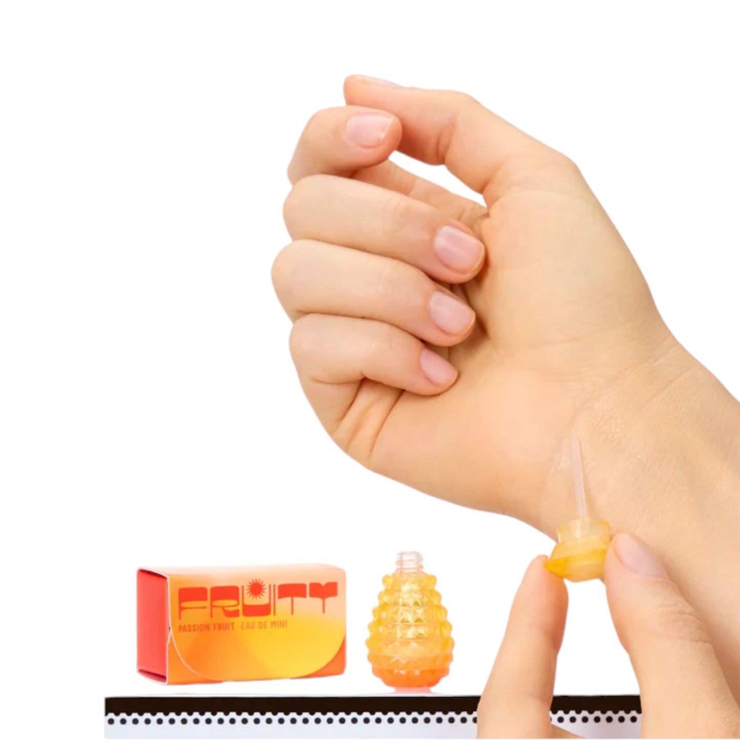 Hand applying a Miniverse Make It Mini Fragrances product on a white background