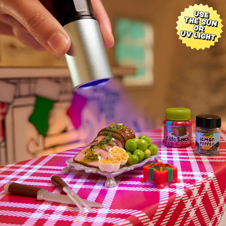 Person using a UV light on a plate of food with a checkered tablecloth and small containers labeled 'Pesto Sauce' and 'Lemon Pepper' from Miniverse Make It Mini Holiday Series 3 surprise capsule