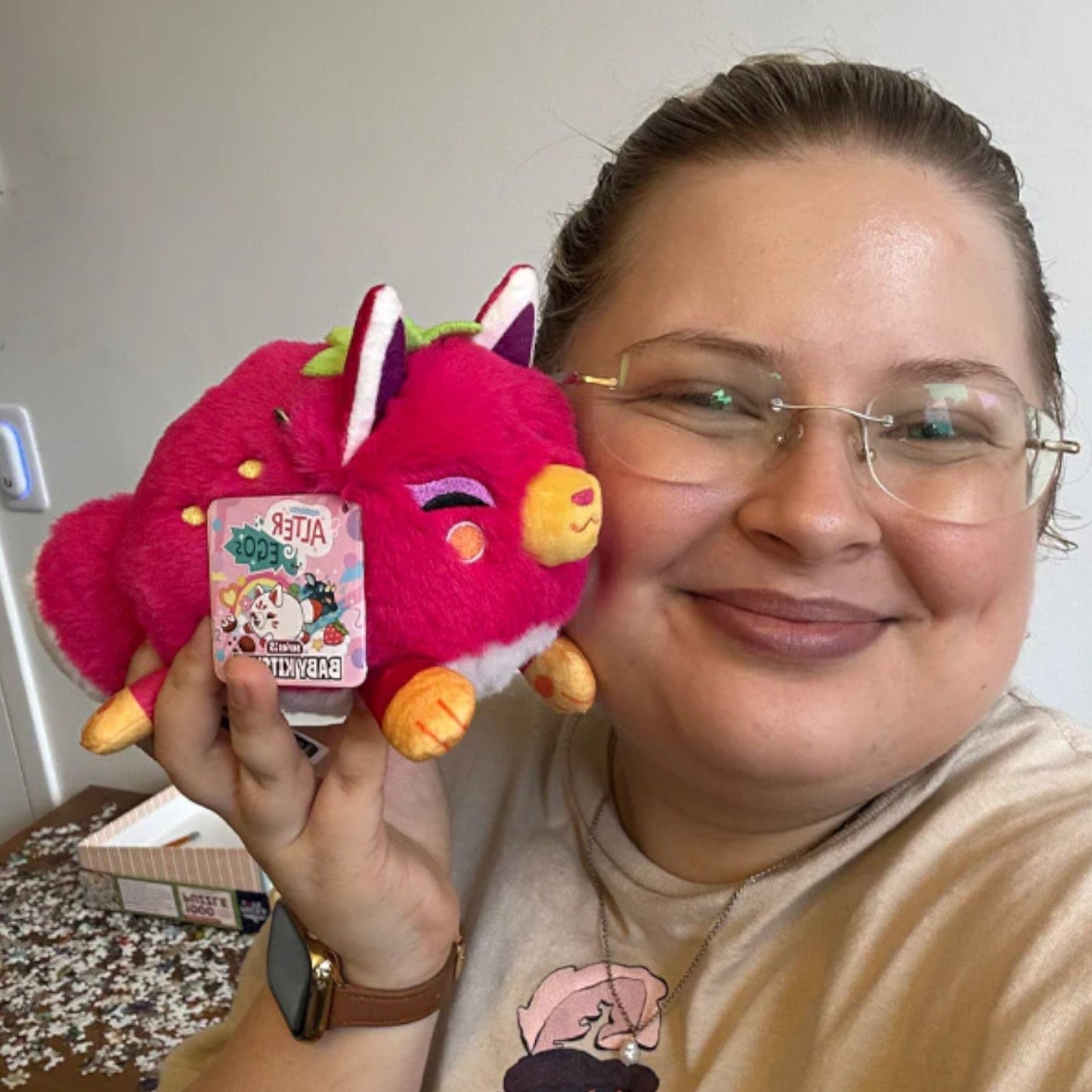 Person holding Squishable Fruity Kitsune plush with vibrant fruit-inspired colors