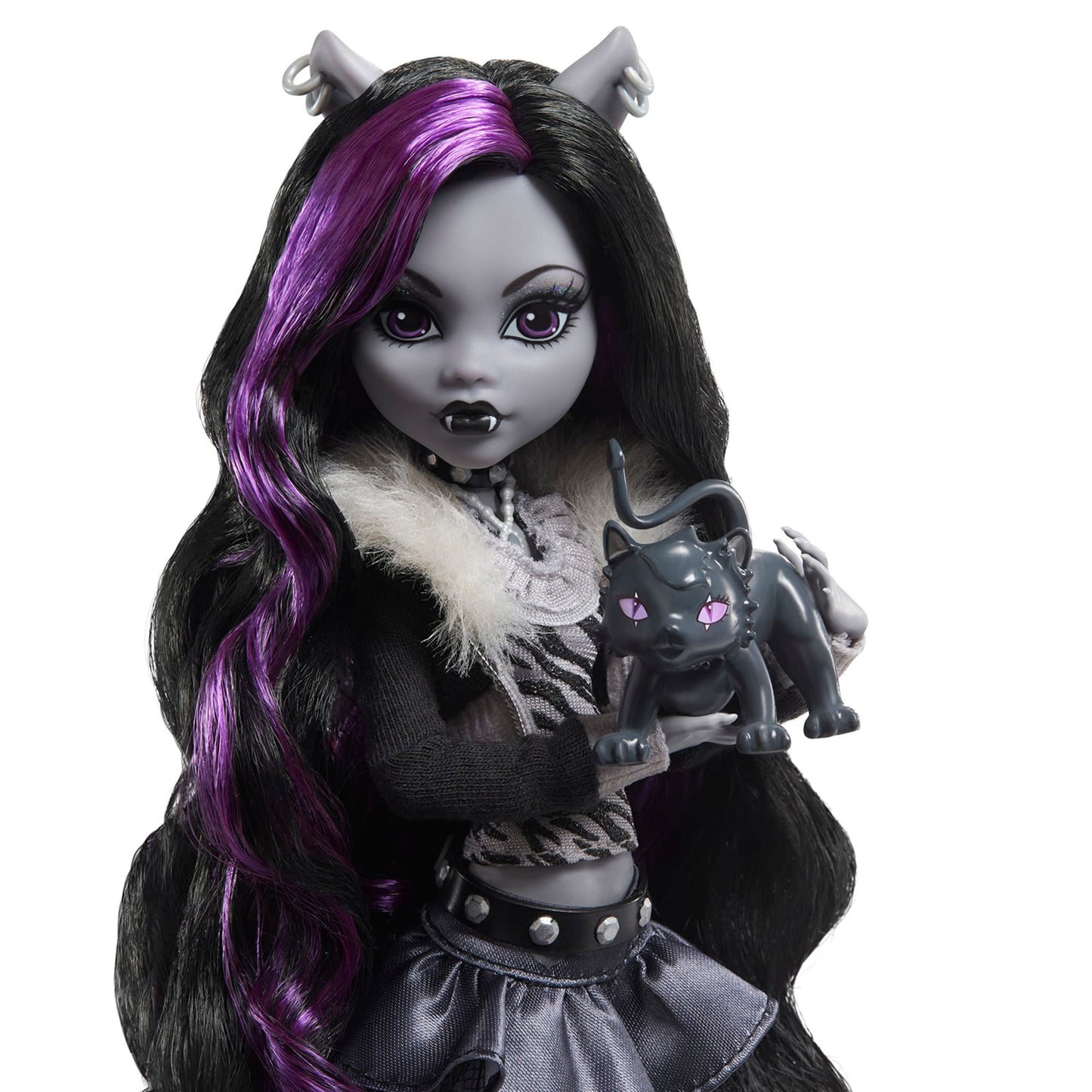 Monster High Reel Drama doll with purple hair and black outfit holding a black cat figurine on a white background