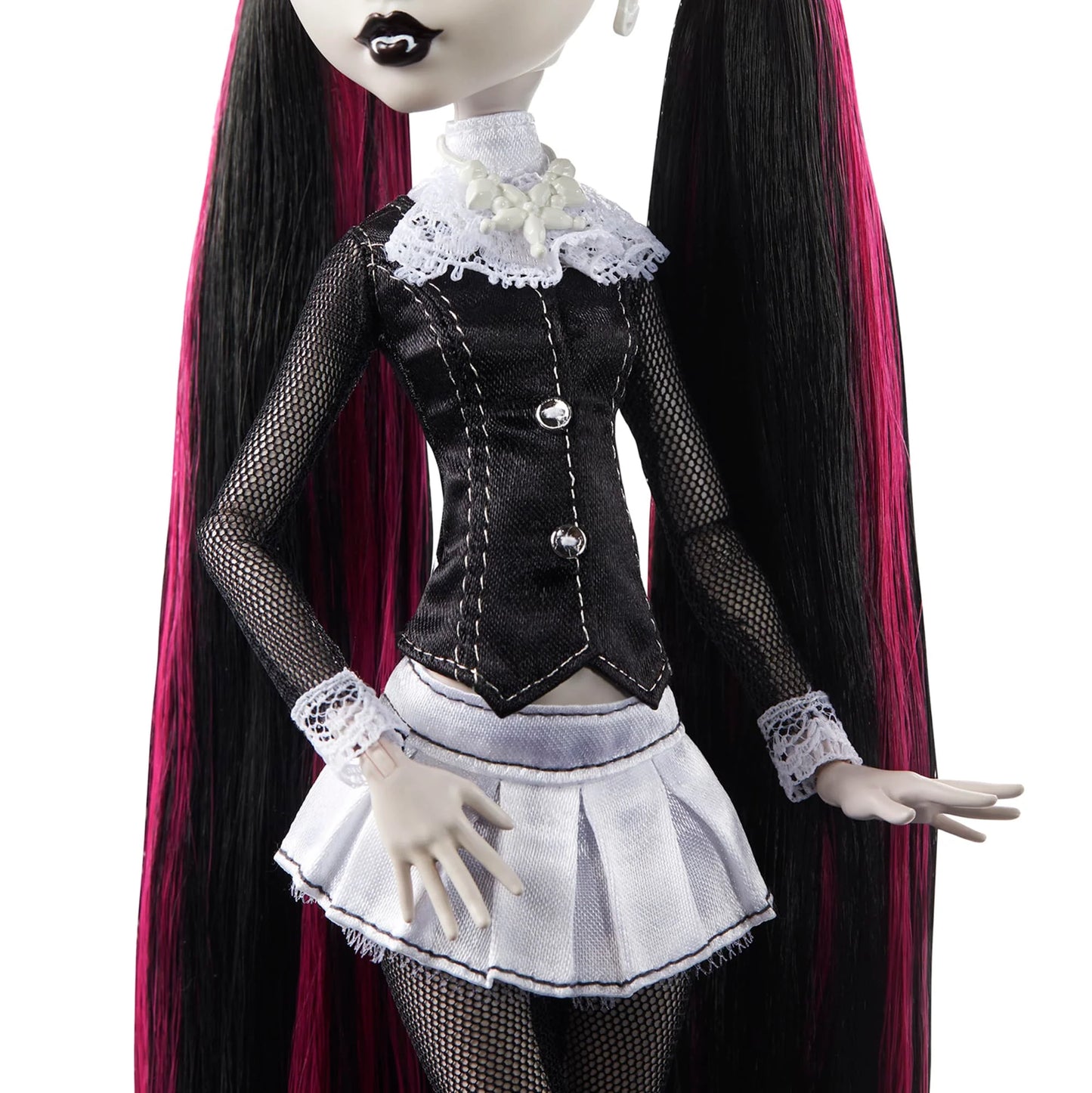 Gothic-style doll with long black hair and a black and white outfit on a white background
