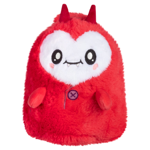 Red plush toy with a happy face and small horns on a white background