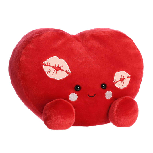 Angled view of Aurora Party-Sized Palm Pals Kimi Kisses Heart, a large 13-inch red plush heart.