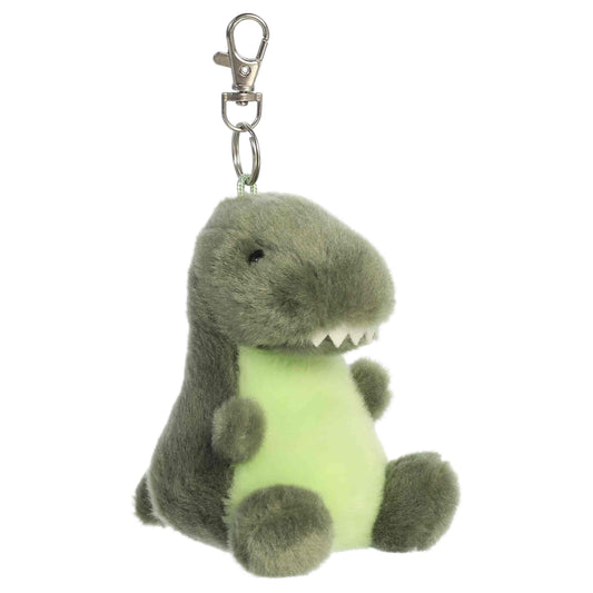 Aurora Palm Pals Tyranno Rex plush clip-on featuring soft green fur, light green belly, felt teeth, and a silver swivel clasp.