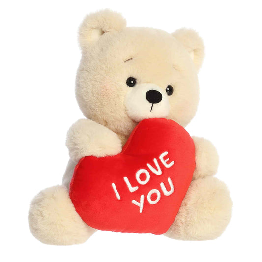 Plush teddy bear holding a red heart with 'I LOVE YOU' text on a white background