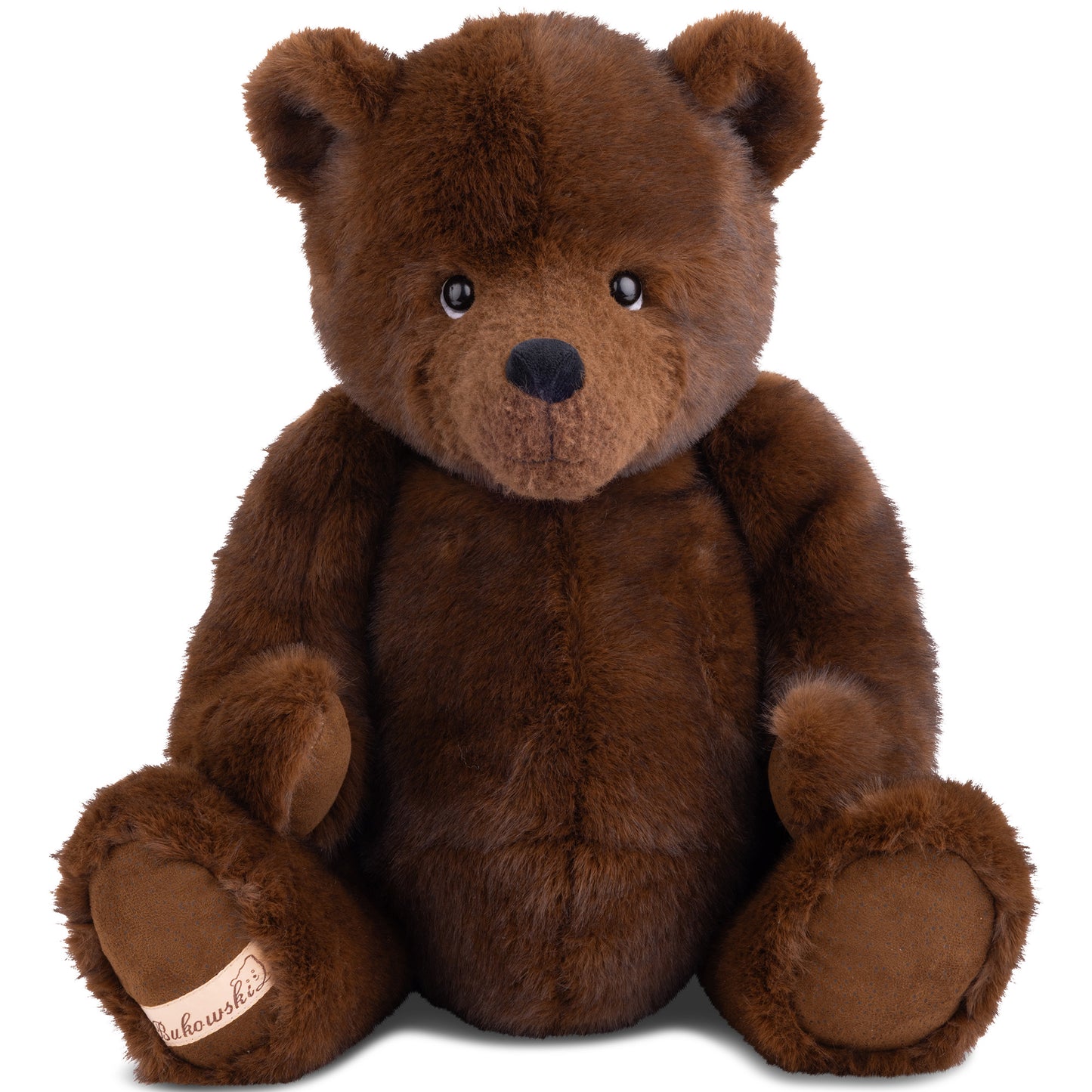 Bukowski Bears John My Treasure plush sitting upright featuring soft dark brown fur and a signature Bukowski logo patch on his foot.