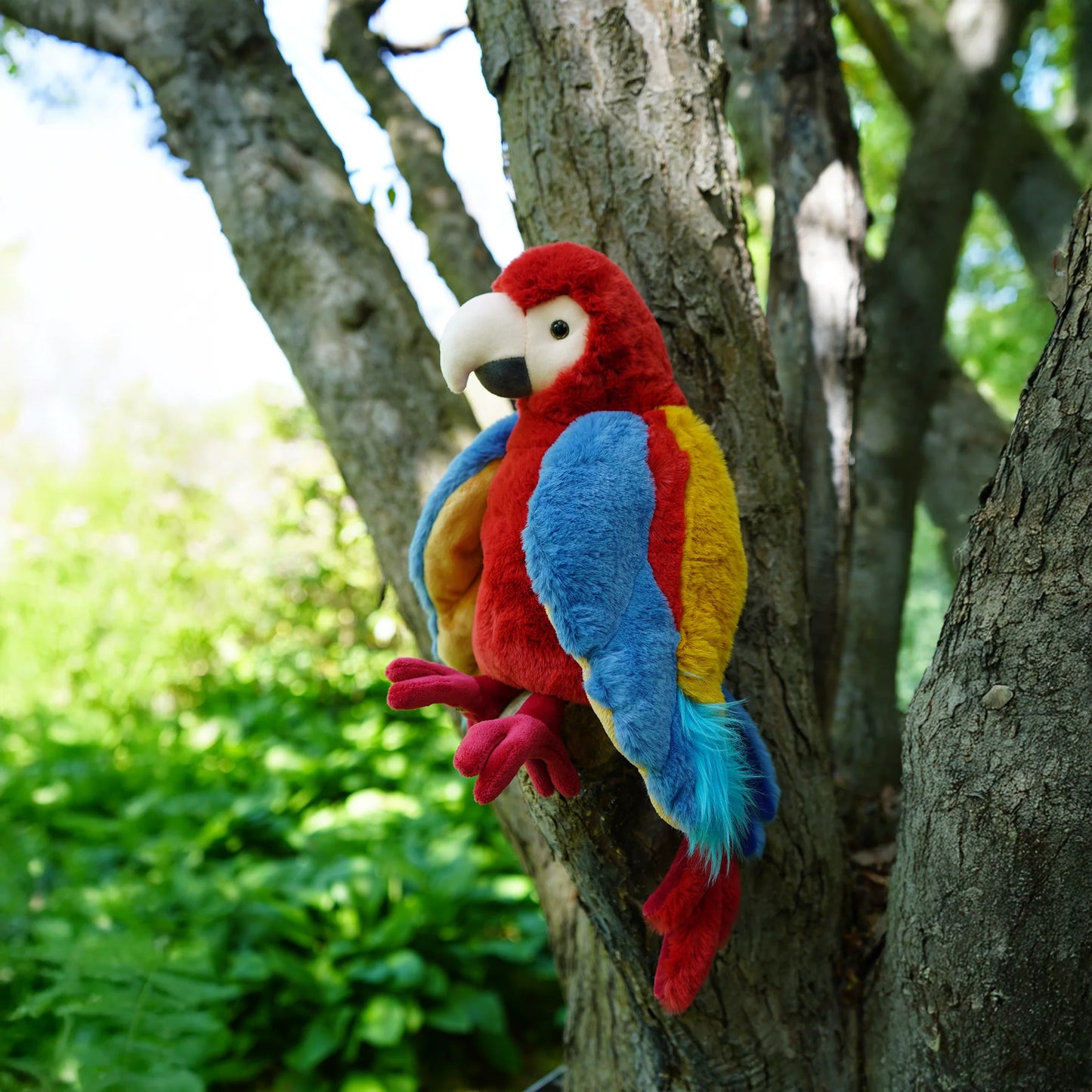 Bukowski Bears Papaya parrot plush featuring soft, vibrant feathers in vivid red, bright blue, and sunny yellow.