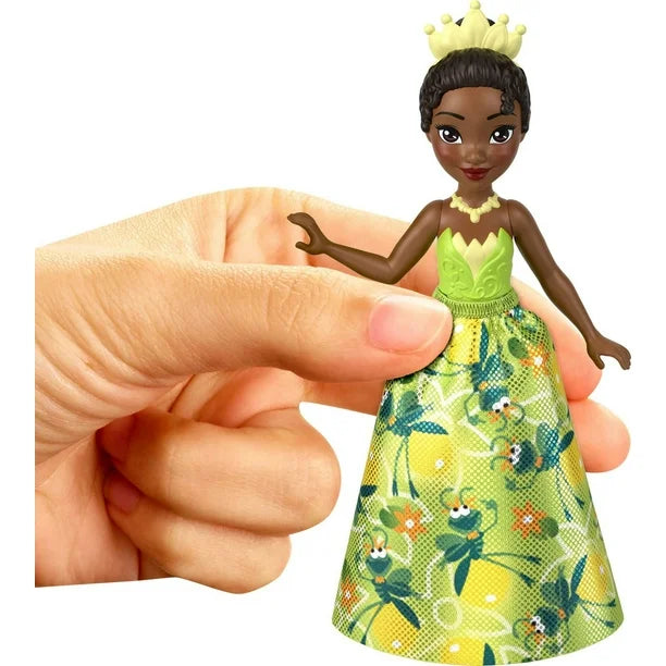 Girl holding Disney Princess & Friends small doll Tiana