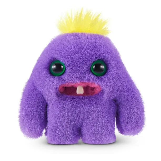 A small, roundish purple Fuggler Baby Fugg plush toy (Mr Needles) with large green eyes, two white baby teeth showing, and a bright yellow tuft of hair on top.