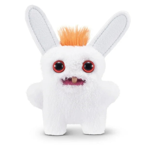 A small, white Fuggler Baby Fugg plush toy (Rabid Rabbit) with long white rabbit ears, large red eyes, one white baby tooth showing in a pink mouth, and a spiky orange tuft of hair on top.