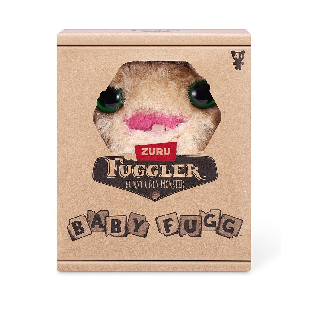 A small, yellowish-beige Fuggler Baby Fugg plush toy (Screech) with large green eyes, one white baby tooth showing in a pink mouth, and a spiky brown tuft of hair on top in display box