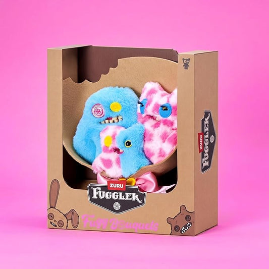 Fuggler Fugg Bouquets Plush Set featuring two 9-inch and one 3.5-inch blue and pink monster plush toys wrapped in craft paper with a pink ribbon.