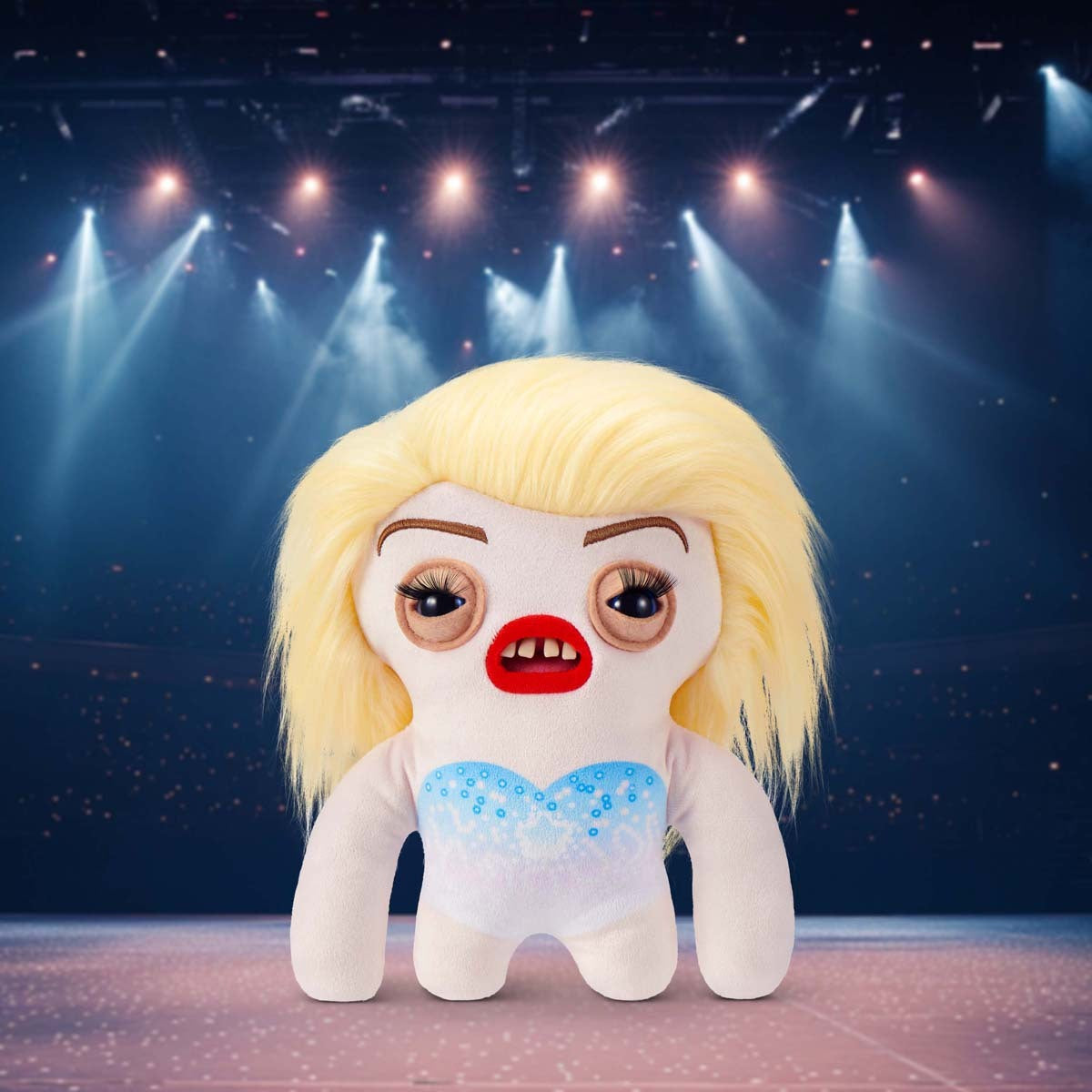Fuggler Fuggstars Series 1 Fleeting Fartlet plush with a performing stage in the background
