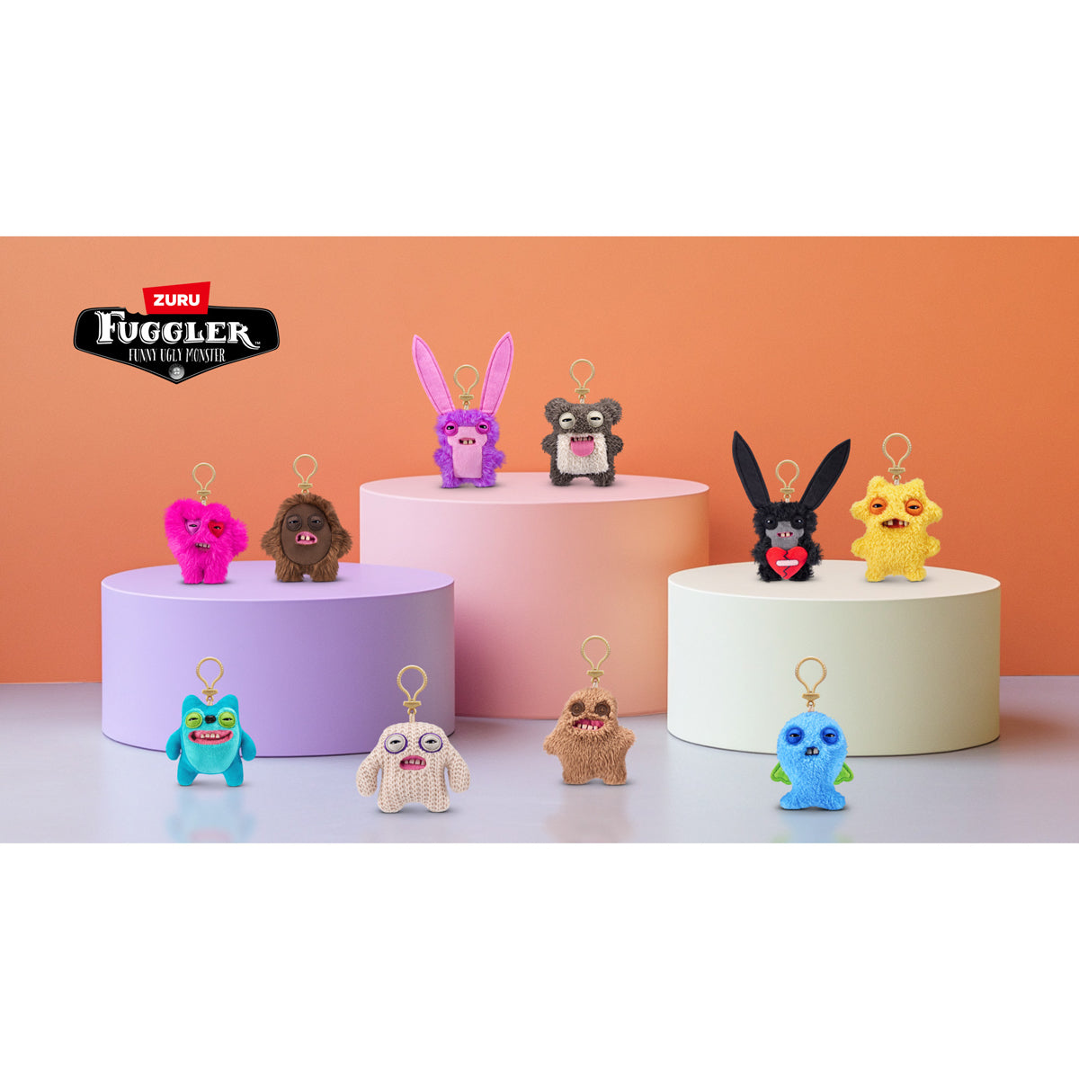 Colorful keychains on cylindrical stands with Zuru Fuggler logo.