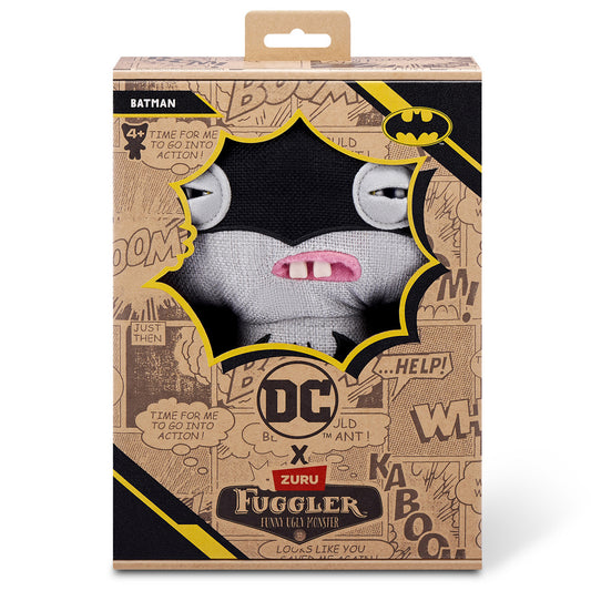 The Fuggler x DC Batman plush inside its collector box, featuring comic book style graphics, the "Batman" name tag, and the Bat-Signal logo.