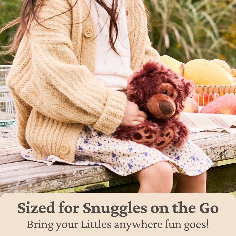 Child holding a Gund Forever Friends Littles Philbin 7″ plush teddy bear with text about snuggles on the go