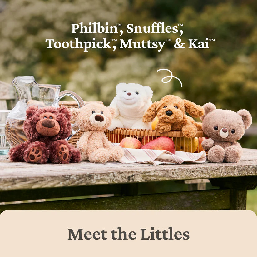 Collection of Gund plush toys including Philbin, Snuffles, Toothpick, Muttsy, and Kai on a wooden table outdoors.