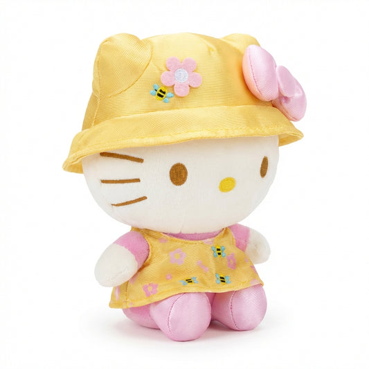Hello Kitty and Friends plush featuring Hello Kitty wearing a yellow bucket hat and cape with pink flowers and bee details, along with her signature pink bow.