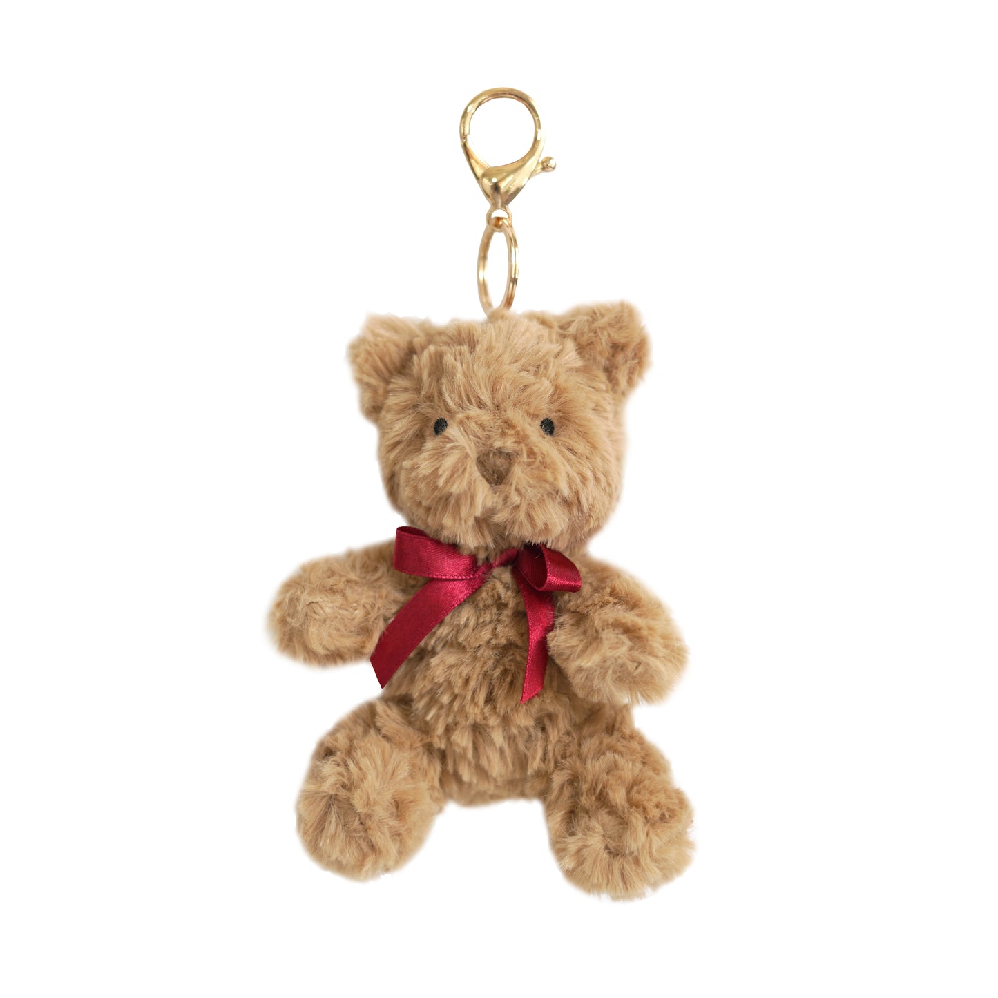 Mon Ami 3-inch Huggie Bear Bag Charm featuring a soft brown plush bear with a red ribbon and a gold-tone metal clasp.
