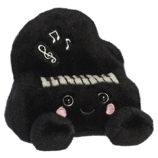 Palm Pals Ragtime Piano plush toy in black with embroidered piano keys, white musical notes, a cute smiling face, and pink blush.