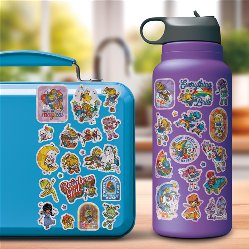 Blue lunchbox and purple water bottle with colorful stickers on a blurred background