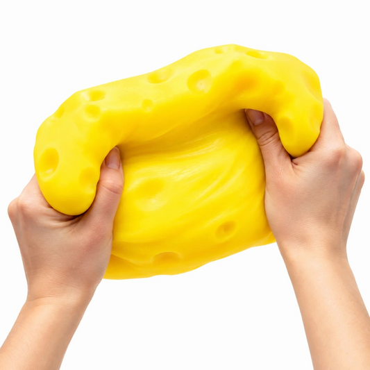 A jumbo authentic RMS Crazy Fun SmushMart Giant Cheese Block squishy fidget toy packaged in a vibrant yellow display box.