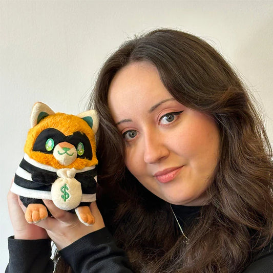 Squishable Alter Egos Series 18 Cat Burglar Kitty 5.5-Inch Plush, an orange cat soft toy in a striped burglar outfit holding a money bag