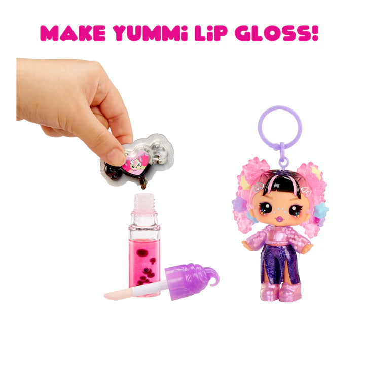 Yummi lip gloss set with a toy figure and lip gloss bottle on a white background