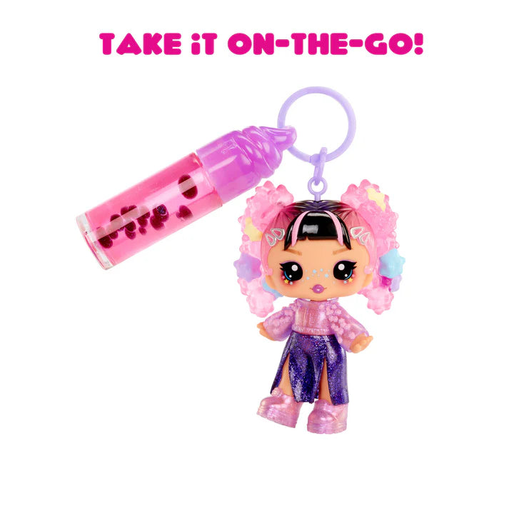 Keychain with a small doll and pink container labeled 'Take it on-the-go!' on a white background