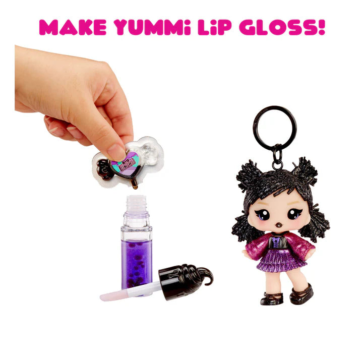 Make Yummi lip gloss set with a small doll keychain on a white background