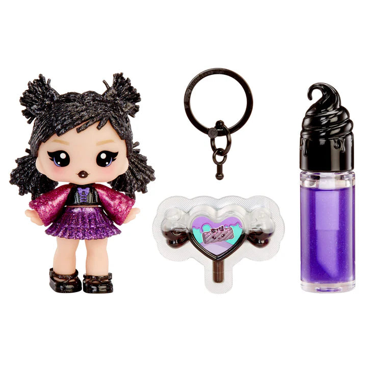 Yummiland Sour Sweeties Blake Licorice doll with sparkly black hair in pigtails, wearing a purple and pink outfit, shown with DIY lava lamp lip gloss kit components including purple lip gloss tube, scented drop packet, and keychain ring.