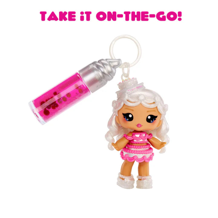 Keychain with a small doll and pink and silver bottle on a white background with text 'Take it on-the-go!'.