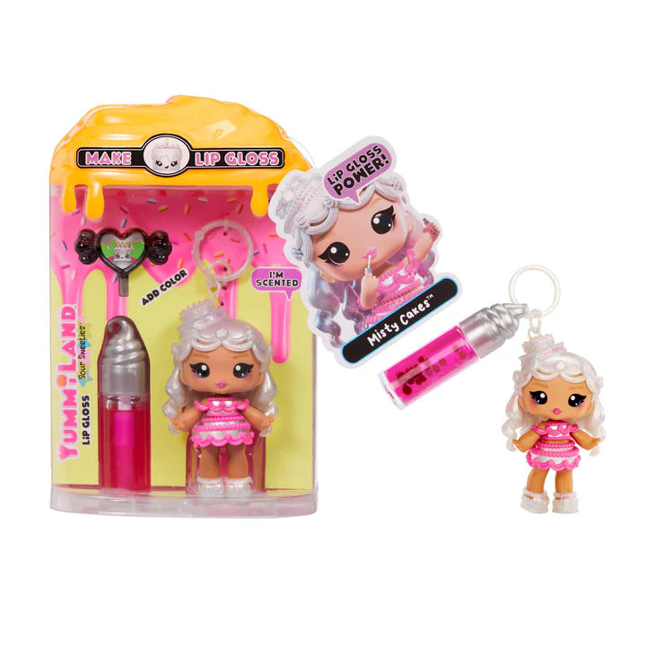 Yummiland Sour Sweeties Misty Cakes doll with white hair styled like frosting and a cake hat, wearing a pink layered dress, shown with DIY lava lamp lip gloss kit components including pink lip gloss tube, scented drop packet, and keychain ring.
