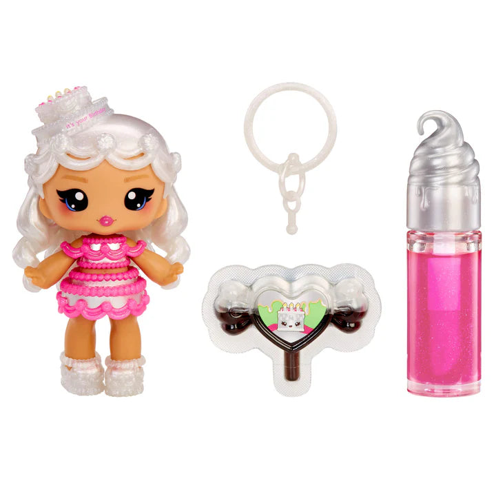 Yummiland Sour Sweeties Misty Cakes doll with white hair styled like frosting and a cake hat, wearing a pink layered dress, shown with DIY lava lamp lip gloss kit components including pink lip gloss tube, scented drop packet, and keychain ring.