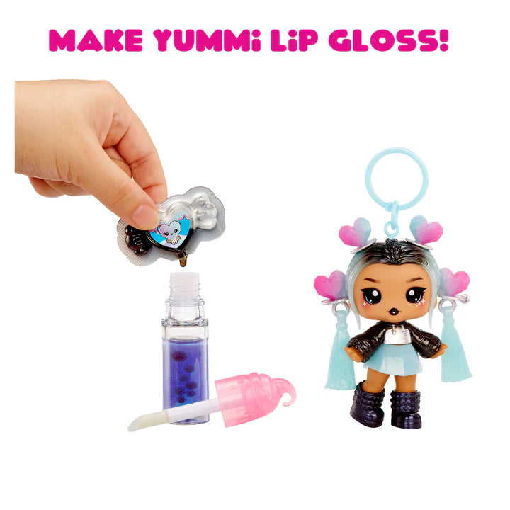Make Yummi Lip Gloss set with a doll and lip gloss components on a white background.