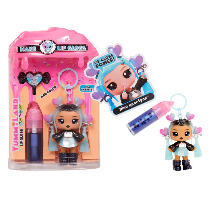 Yummiland Sour Sweeties Nina Heartpop doll with blue hair featuring pink and blue heart accents, wearing a black jacket and blue skirt, shown with DIY lava lamp lip gloss kit components including blue lip gloss tube, scented drop packet, and keychain ring.