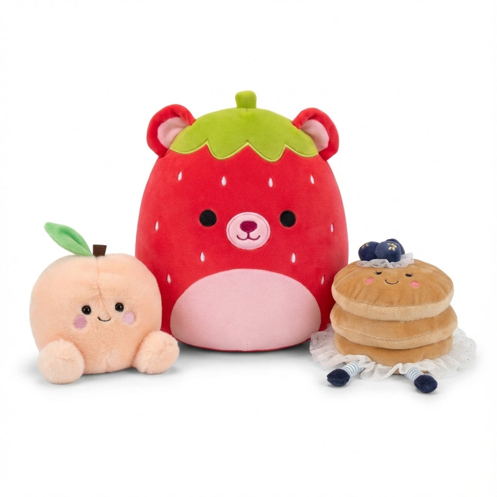 A variety of food-themed plush toys featuring a peach, a strawberry bear, and a stack of pancakes from the ReChild Food & Drink collection.