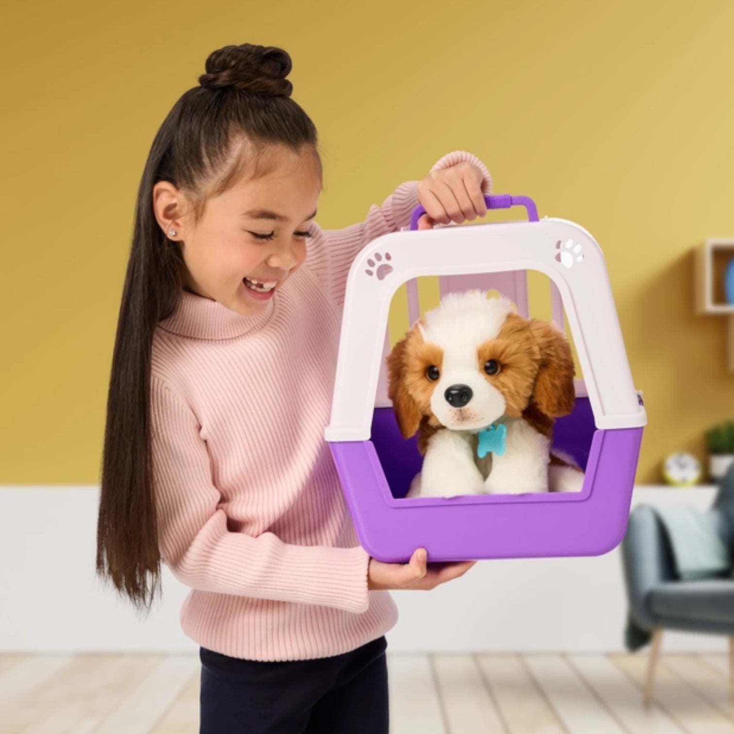Child holding a purple pet carrier with  Little Live Pets - My Really Real Puppy Patches inside against a yellow wall.
