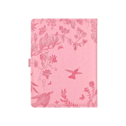 Pink notebook with floral and bird pattern on a white background