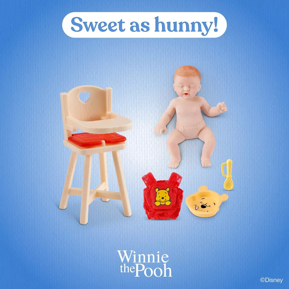 Baby doll with high chair, bag, and toys on a blue background with 'Winnie the Pooh' branding.