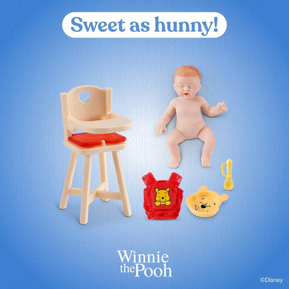 Baby doll with high chair, bag, and toys on a blue background with 'Winnie the Pooh' branding.