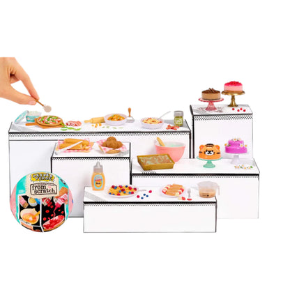 Miniverse Make It Mini From Scratch Series 2 Miniature food set with a hand holding a toy spoon over a white surface