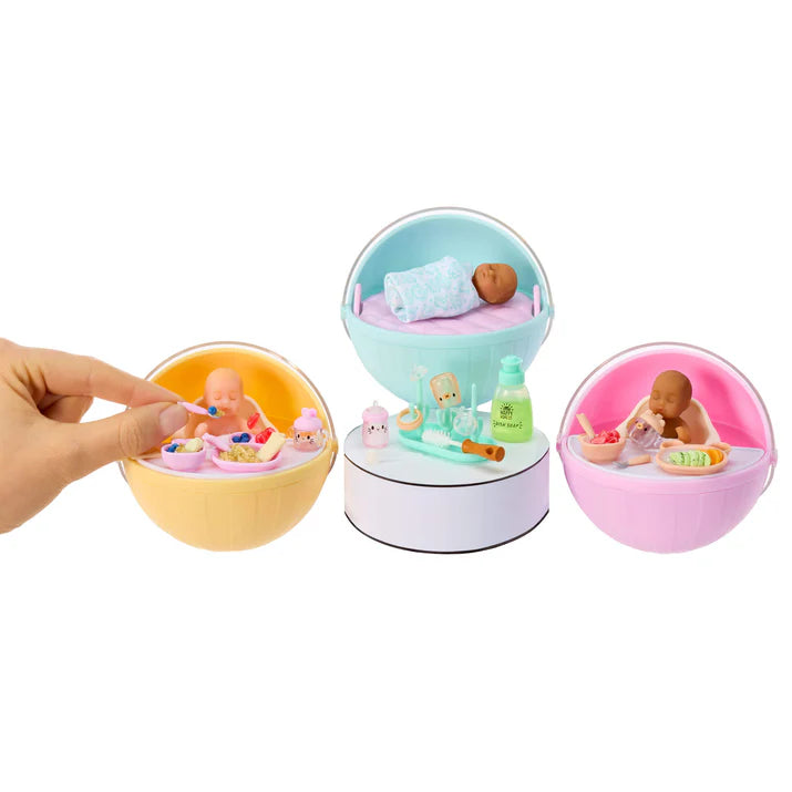 MGA's Miniverse Make It Mini Real Baby Series 1 surprise capsule with miniature baby doll, high chair, and crafted baby food.
